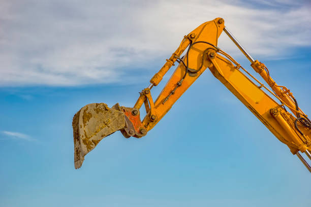day view of single excavator boom arm with hydraulic Hoses and cylinder in action. Close