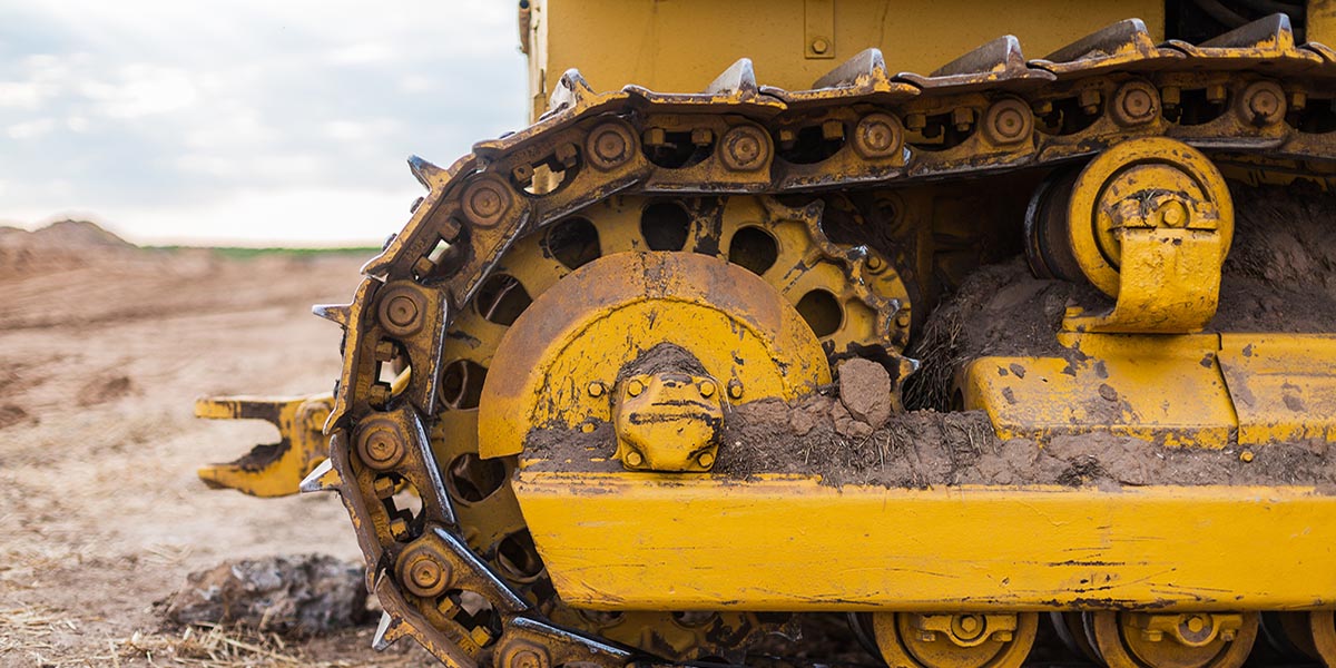 Yellow Tractor on caterpillar tracks, tractor tracks